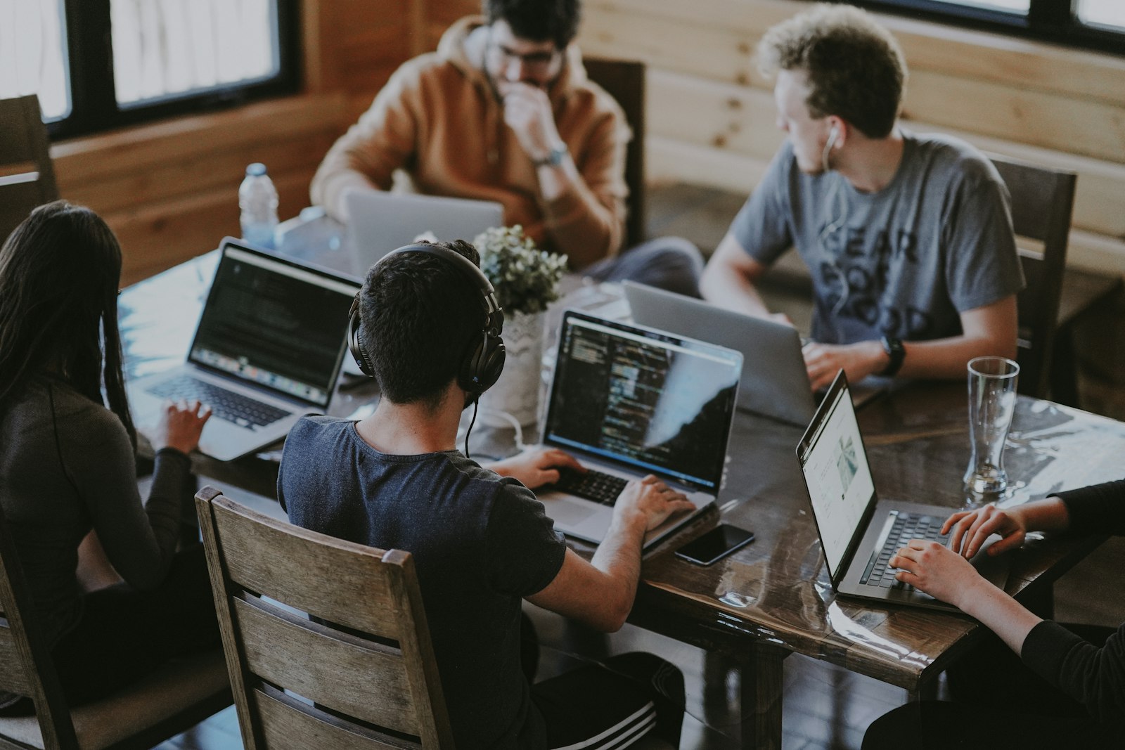 Developers working through a technical problem together on laptops